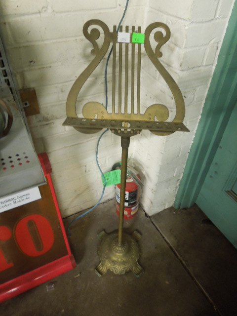 Brass Lyre Form Sheet Music Stand: Brass lyre form sheet music stand, extends to 3 1/2" tall. CONDITION: Good, slight oxidation, missing connector piece.
