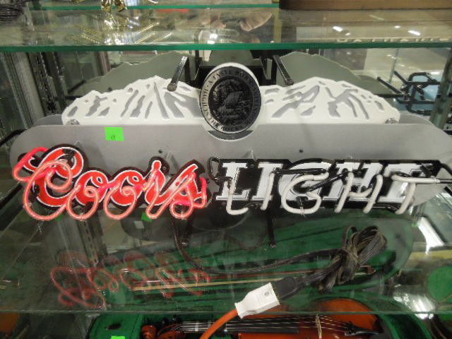 Coors Light Neon Beer Sign: Coors Light neon beer sign. Measures: 33" wide x 11" tall 10" deep. CONDITION: Partially works, "Light" part has broken neon tube.