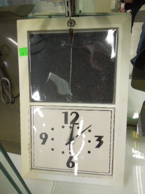 Battery Powered Ad Wall Clock: Battery powered advertisement wall clock. Insert your own advertising / specials with key. Measures: 13 3/4" wide x 20 3/4" tall x 1" deep. CONDITION: Fair, some discoloration.