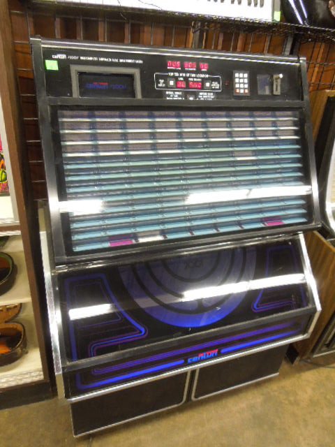 1980s Centuri Model 2001 Jukebox: 1980s Centuri model 2001 jukebox, holds 310 selections. 45 rpm records, lights up with digital display. Measures: 41" wide x 56" tall x 21" deep. CONDITION: Good, used, not working, lights, does not p