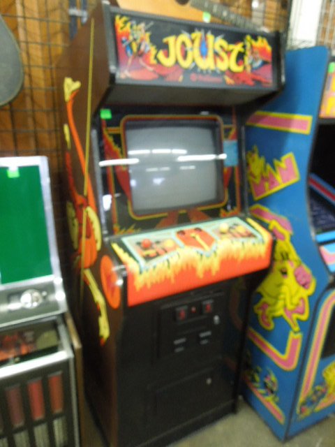1983 "Joust" Arcade Machine by Williams: 1983 "Joust" arcade machine by Williams (upright). Measures: 26" wide x 70" tall x 28 1/2" deep. CONDITION: Cabinet has been repainted. Powers up, no sound, no display.