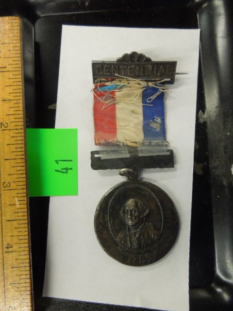 1889 Centennial Inauguration Badge: 1889 Centennial Inauguration Badge; featuring bottom medal Harrison / Morton & Geo. Washington on reverse, with red white & blue ribbon. CONDITION: Ribbon worn & as is, attached with scotch tape to bo