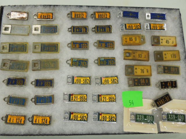 43 Vintage License Plate Keychain Fobs: Forty-three vintage license plate keychain fobs. Pennsylvania, New Jersey & others including: Pa two 1949 & (15) pairs 1940s-70s, plus (8) N.J. 1947, (4) 1950, (2) 1952 & (1) 1953, (1) N.Y. 1950 & pai