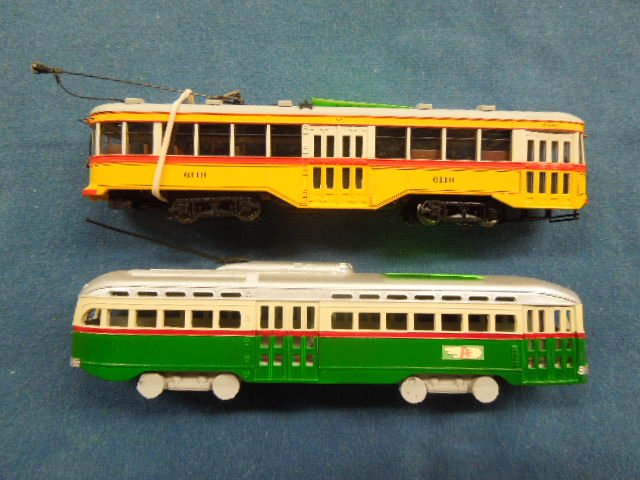 2 HO scale Trolley Car Models: (2) HO scale Trolley car models, Spectrum by Bachmann, in metal (1) 6119, yellow with red stripe, grey top and (1) plastic PTC (small decal on sides) green with red stripe, grey top, both 6 1/2"L. CON