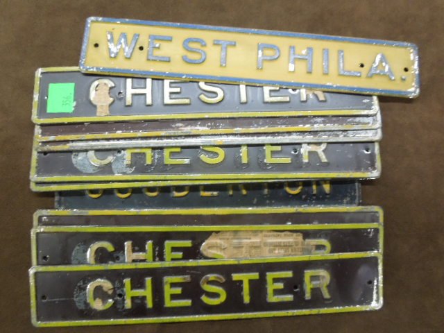 Vintage PRR, et al, Station Name Plaques: [12] Vintage Pennsylvania Railroad. [one of which Reading Railroad] painted tin station name plaques, early 20th c. CONDITION: Most in generally good condition, with minor to moderate paint loss.