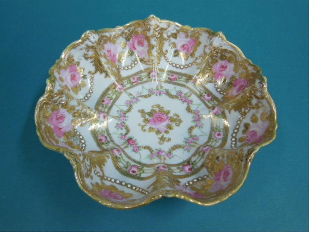 Nippon Porcelain Bowl: Nippon porcelain bowl, deep scalloped rim with gilt work, beading & red painted roses, c1900, 10" d, 3 1/8" h. CONDITION: Wear to gold on rim.