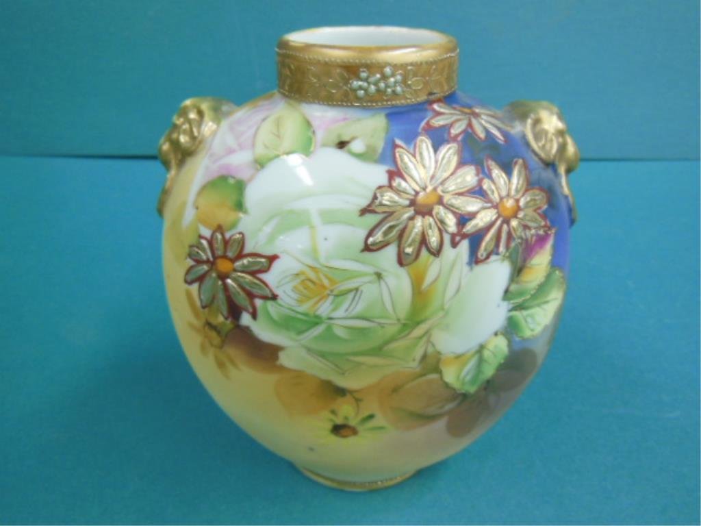 Nippon Poreclain Vase: Nippon porcelain vase, pillow form, gilt rams head handles, border & floral designs, c1900, 6 1/2" h. CONDITION: Gilt wear in handles & top rim.