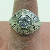 18k WG Deco Diamond Ring: 18k WG Deco Diamond Ring, round solitaire 1 ct mine cut diamond set in domed filigree mounting, 3 round accent diamonds on each side of stone, 2.2 DWT. size 6. No appraisal. Inclusions observed with 1