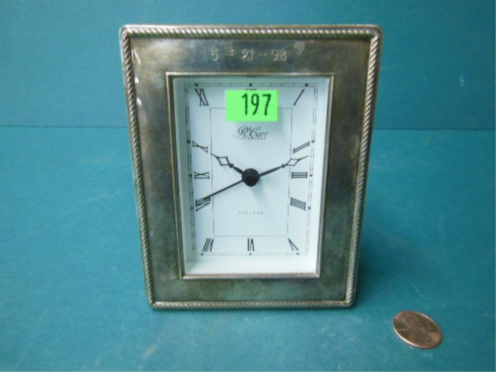 Sterling Silver Desk Clock: Sterling silver desk clock, rope bordered frame with date" 5-21-98" & monogrammed "CNS", distributed by R. Carr, England, quartz alarm movement, 3 3/4" x 4 3/4", late 20th C. CONDITION: Needs battery,