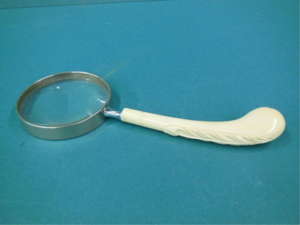 Magnifying Glass: Magnifying glass walrus ivory shaped handle with carved leaf, nickle plated lens housing marked "Swift & Anderson Inc. Boston", early 20th C., length 9 3/4", diameter 3 1/2". CONDITION: Good, modest u