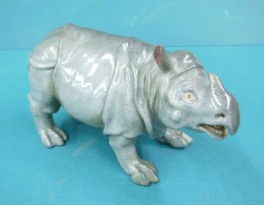 Meissen Porcelain Rhinoceros: Meissen porcelain rhinoceros, cross sword mark on base, 19th / 20th C., 7" x 3 3/4" x 2". CONDITION: Old repairs to ear, front toes & tail, missing one ear.