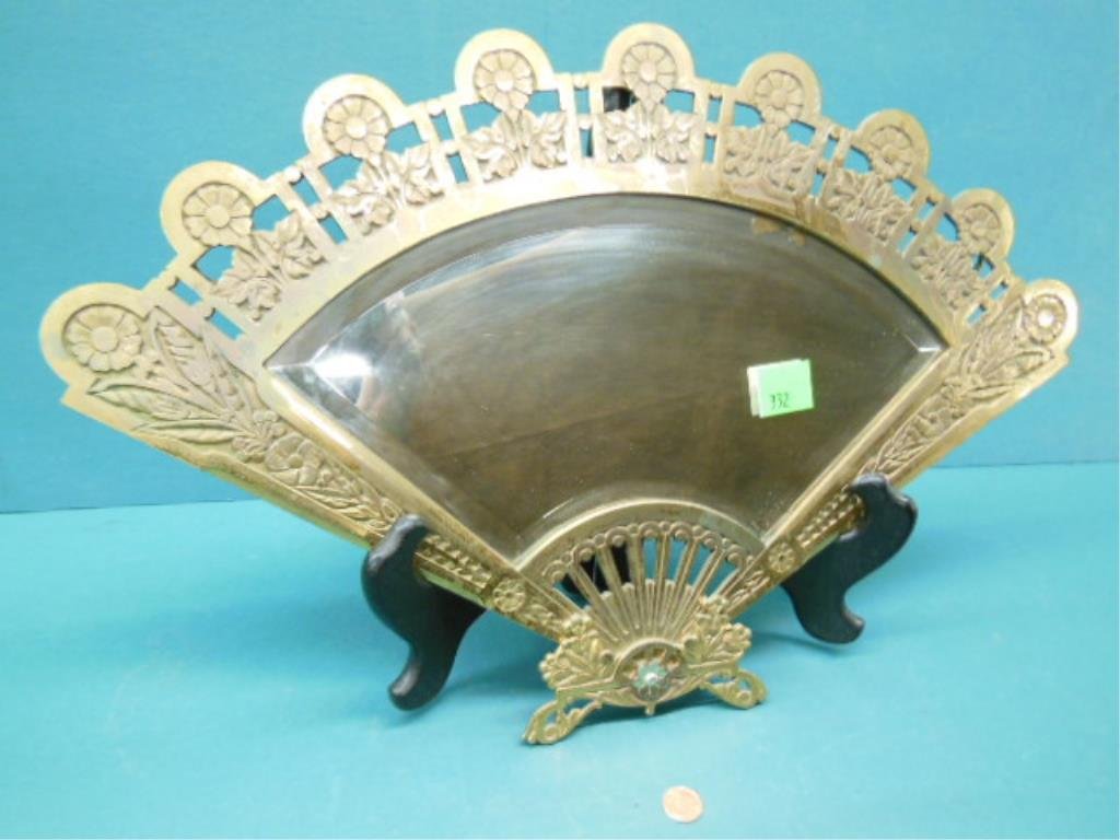 Victorian Fan Form Mirror: Victorian fan form mirror, brass plated over iron, features cast Stems with floral rosettes, beveled mirror, late 19th C., 21" x 13 3/4". CONDITION: Areas of plate wear & loss; 1 1/2" loss to silver o