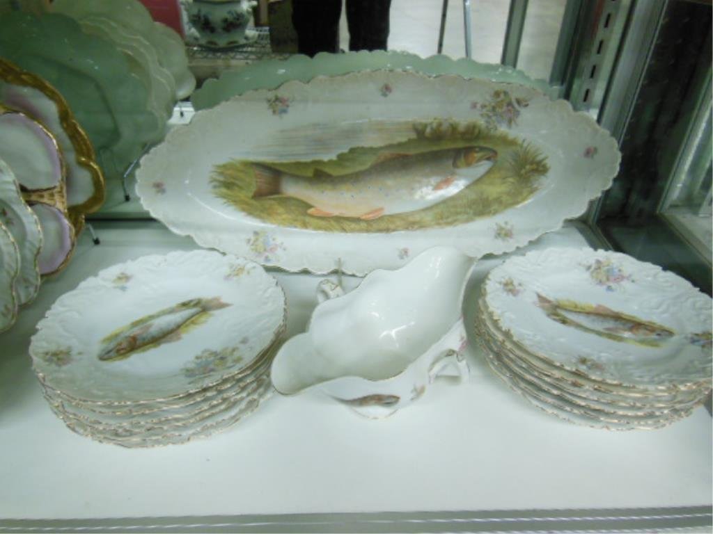 Carlsbad Austria Fish Set: Carlsbad Austria fish set, with transfer decorations & scalloped edges, 10" x 20" fish tray, twelve 7 1/2" plates; 9" gravy boat, early 20th C. CONDITION: Moderate loss of gold edging. No other issues