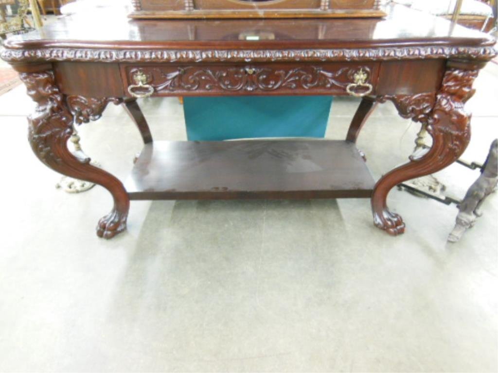 Renaissance Revival Style Partner's Desk: Renaissance Revival Style partner's desk, mahogany, features carved apron with 2 drawers and 4 caryatid carved cabriole legs with base shelf, early 20th c. 53" x 39 1/2" x 29 3/4". CONDITION: Good, re