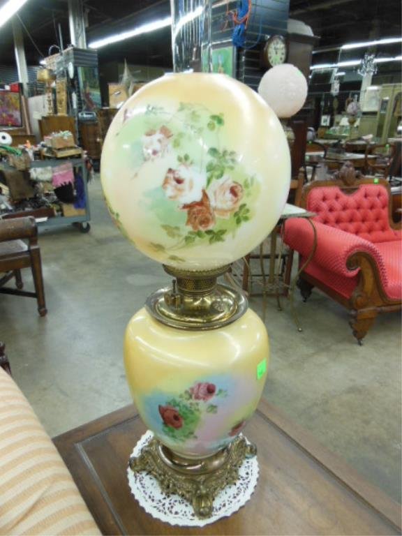 GWTW Lamp: Gone With The Wind lamp, Peach field with painted red roses, original brass and oil fittings, (not electrified), late 19th C. height to chimney top 31". CONDITION: Areas of peach color losses on ball
