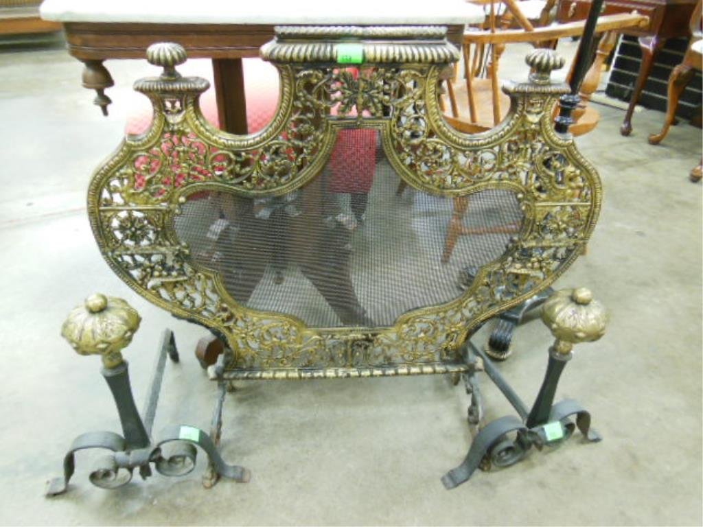 Arts & Crafts Andirons & Screen: Arts & Crafts andirons & screen, pierced brass Renaissance style shield form screen with wire mesh center & wrought iron scroll legs, 31" x 28 1/2", along with wrought iron 16" andirons having engrave