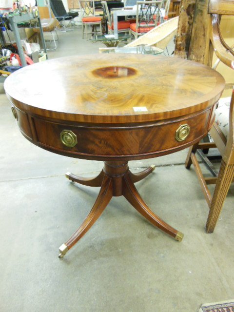Hickory Chair Co. Drum Table: Hickory Chair Co. drum table, Duncan Phyfe style, banded mahogany, one drawer & 3 faux drawers, turned column with four brass capped sabre legs with casters, mid 20th C. 29 1/2" d, 27 1/2' h. CONDITIO