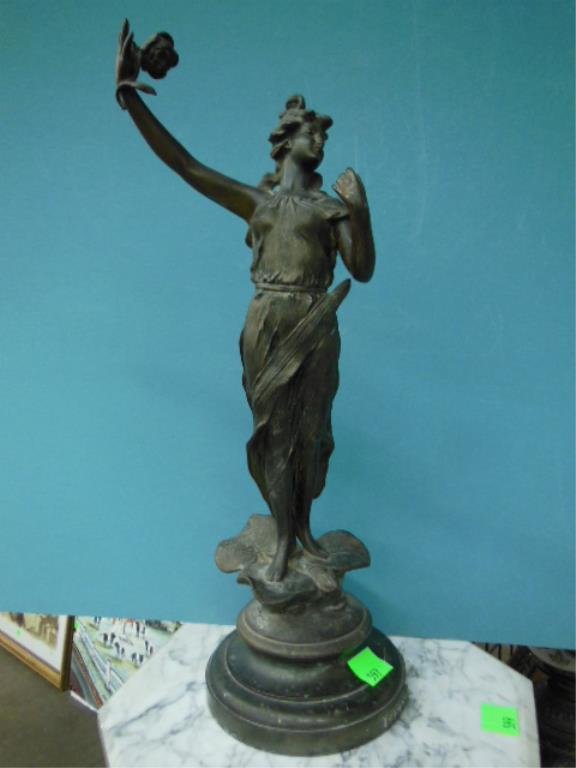 "La Rose" Sculpture: "La Rose" sculpture, bronze finished spelter metal, depicts a draped maiden holding a rose & standing upon a lily pad, circular base, 18 1/2" h. CONDITION: most of bronze finish worn, drilled at base 