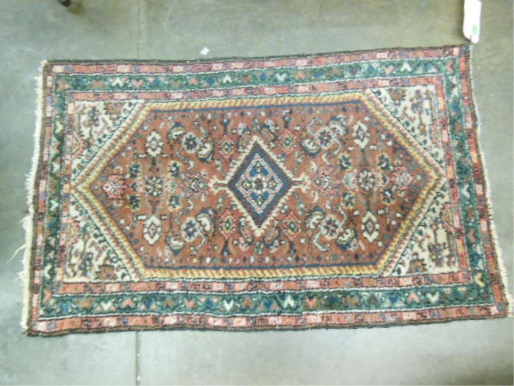 Hamadan Throw Rug: Hamadan throw rug, in brown, forest green, ivory & red geometric & floral patterns, early 20th C., 2'4" x 3'10". CONDITION: Losses to fringe edges.