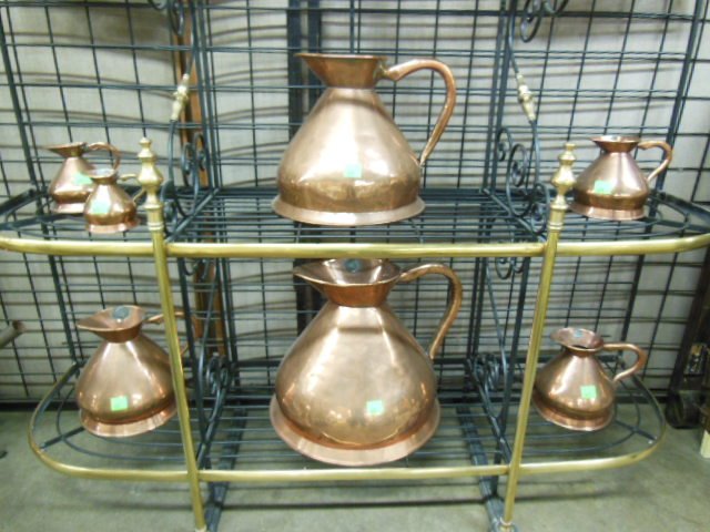 English set of 7 Copper Wine Measures: English set of 7 Copper Wine Measures, with applied metal labels "W.R. Loftus Limited London", and lead weight accuracy seals, includes: 4, 2, 1, 1/2 gallon, quart, pint, 1/2" pint, circa 1870. CONDIT