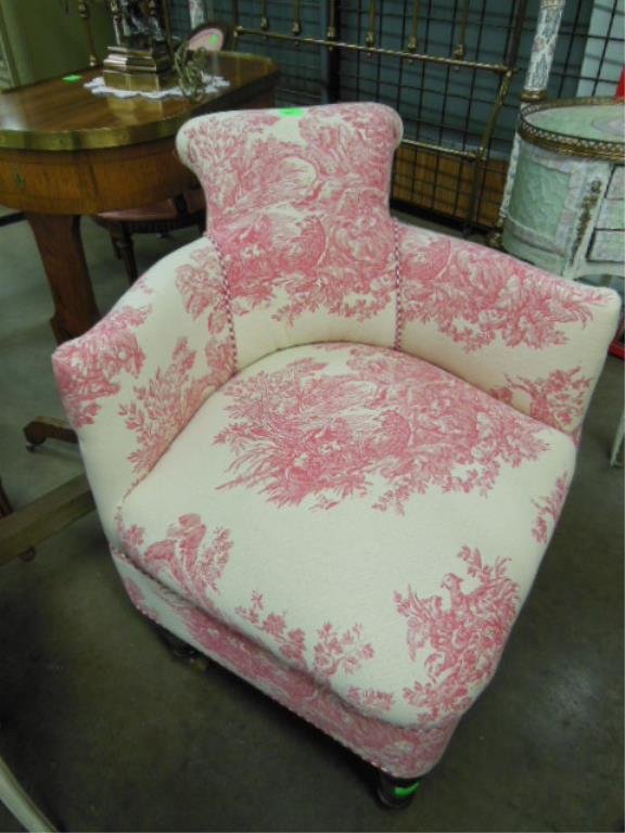 Boudoir Corner Chair: Boudoir corner chair, rolled back & shaped arms upholstered in ivory & red printed sheep in landscape print, turned legs on casters, 20th C., 30" h. CONDITION: Very good.