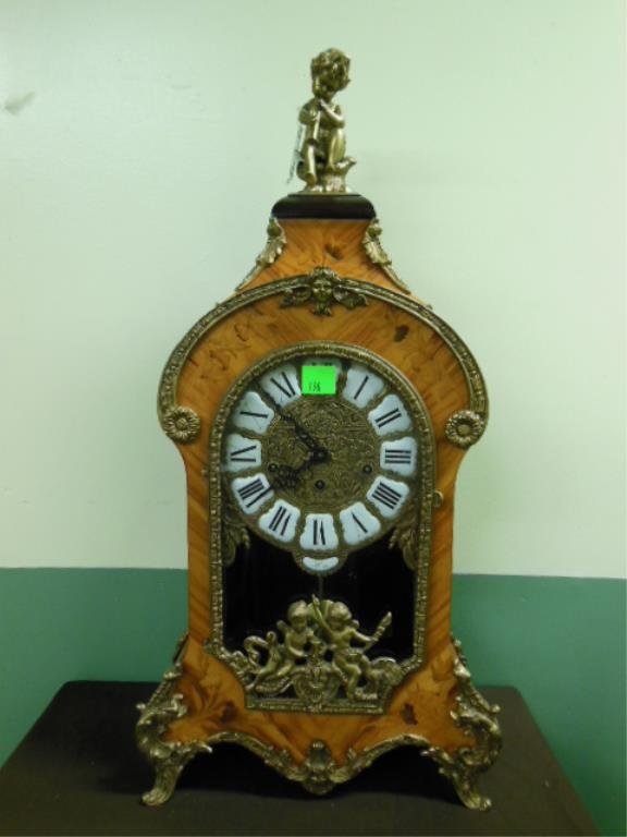 Louis XV Style Mantel Clock: Louis XV style mantel clock, floral marquetry case with brass flute playing putti crest & acanthus, scroll, rosette & putti mounts, brass & porcelain dial, time strike & chime key wind movement, made 