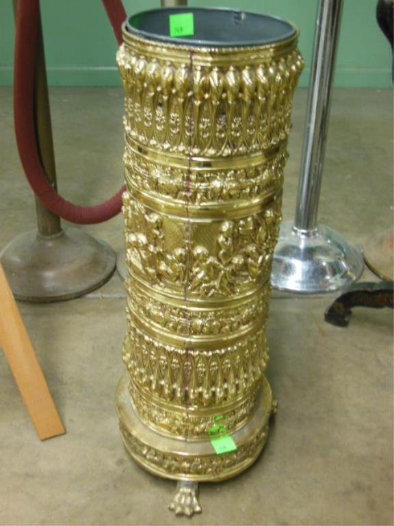 Renaissance Style Umbrella Stand: Renaissance style umbrella stand, embossed brass in cylindrical form, employing borders of putti, grape clusters & Gothic style geometric patterns, three claw feet, tin liner, 19th / 20th C., 26" h. C