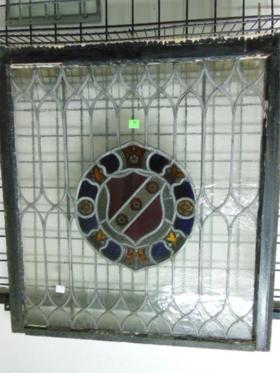 Framed Leaded Glass Window: Framed leaded glass window, floral crest center design, 34 1/4" x 37 1/4", circa 1900. CONDITION: Some wear to frame, minor indenting in center, some surface imperfections, one center border medallion