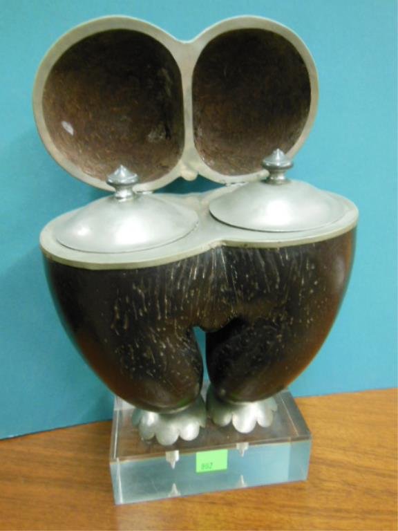 Erotic Gourd Tea Caddy: Erotic gourd tea caddy conjoined black gourd type shells in pelvic form & pewter trim & double lift lid interior, rests upon pewter petal form feet & lucite base, possibly Oceanic 16" h., mid 20th c. 