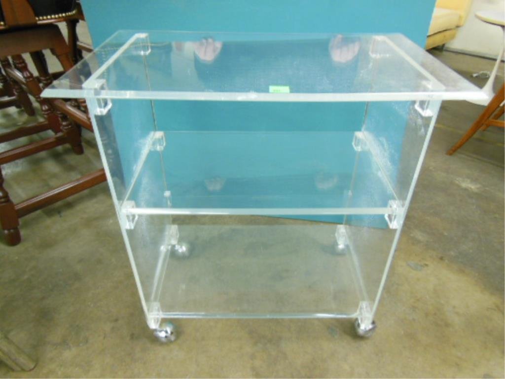 Lucite Tea Cart: Lucite tea cart, 3 shelves with beveled edges, chromed casters, c. 1970-80, 27" x 16" x 28 1/2". CONDITION: Large areas of fogging on plexiglass.