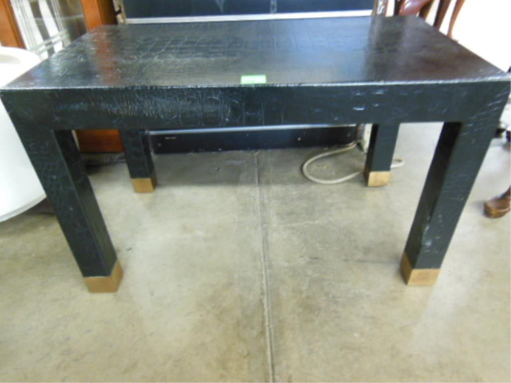 Modern Cocktail Table: Modern cocktail table, black alligator finished leather overall, Parson's form, brass capped feet, late 20th C., 26" x 15" x 16". CONDITION: Good.