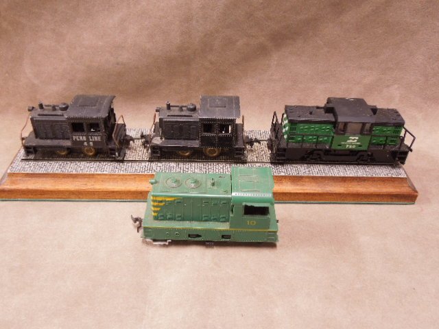 Four HO-Scale small Locomotives: Four HO-scale small locomotives made by Penn Line and other. CONDITION: Fair, used, shows wear.