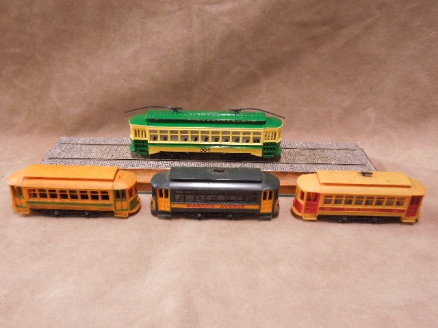 Four HO-Scale Trolley Cars: Four HO-Scale trolley cars made in China. CONDITION: Fair, used.