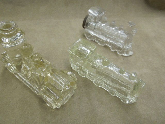 2 Train Form & Other Candy Container: Two train form & other candy container, 888 locomotive, 4 7/8", 999 locomotive 4 3/4" with tin screw cap at end, plus fire engine pumper, Victor Glass Co., Jeannette, PA, 5". CONDITION: 999 locomotive