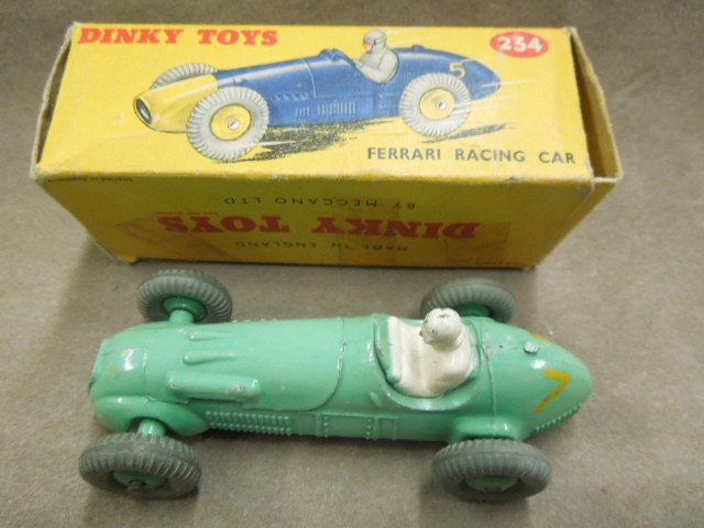 Dinky Toy Race Car, #234: Dinky toy Ferrari racing car, #234, green with white driver, No. 7, 4", mid century. CONDITION: Wear & tape residue on box, some paint wear, minor surface rusting underneath.