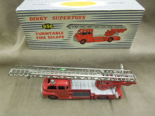 Dinky Toy Fire Ladder Truck # 956: Dinky Super Toys, turntable fire escape, red with double winding ladder lift, original box, 7 1/4", mid century. CONDITION: Minor wear to box, some paint loss, rust & wear on windows.
