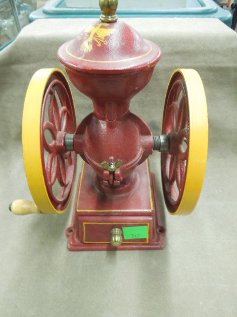 Cast Iron Grinding Mill: Cast iron grinding mill, John Wright Inc. Wrightsville, PA, coffee mill, red with yellow accent around wheels, wood handle, brass finial wood pull out drawer11' with brass knob, 9 1/2' w. CONDITION: M