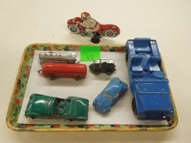 7 small metal vehicles: 7 small metal vehicles including; (3) Tootsie Toy - 1 blue jeep 4 3/4", 1 Triumph TR-3, 3" and 1 Volkswagon 2 1/4", 3 piece train set 6 3/8" (overall length) and tin friction motorcycle Condition; som