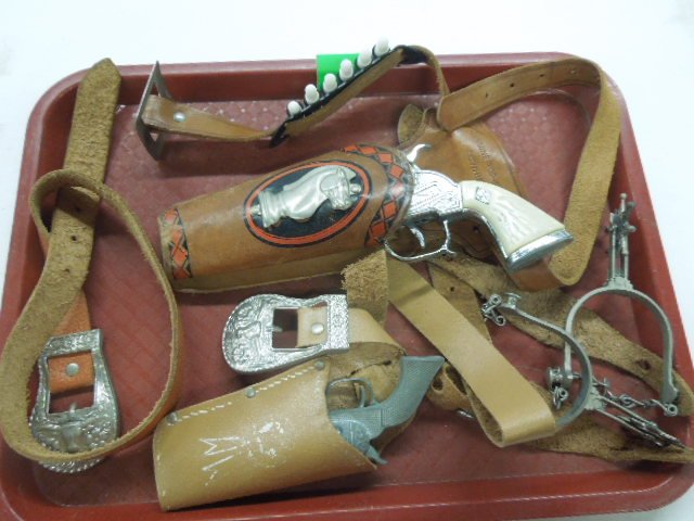 Toy gun belt, guns and spurs: Toy gun belt, guns and spurs including (2) gun belts (1 miniature - Roy Rogers) with pistols, larger belt has plastic bullets, child's belt with longhorn buckle and pair of spurs with star form jangle