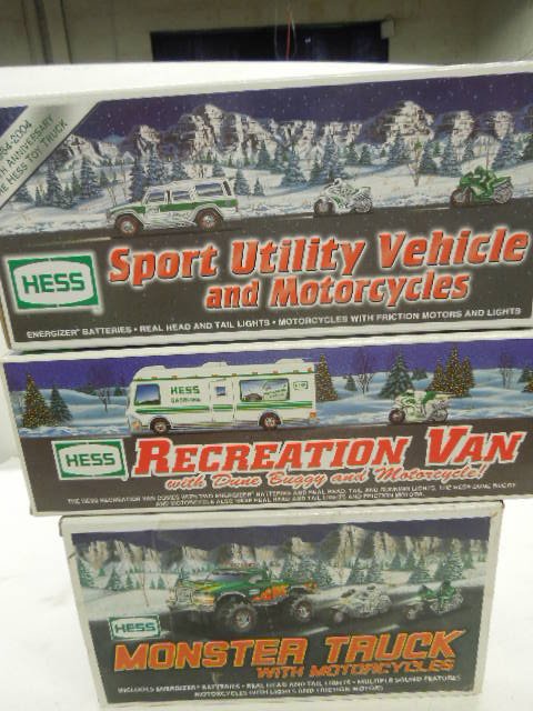 3 Hess Trucks with vehicles: 3 Hess Trucks with vehicles including 1998 Recreation Van with dune buggy and motor cycle, 2004 SUV with motorcycles and 2007 4x4 Monster truck with motorcycles, new in boxes Condition; minor wear to 