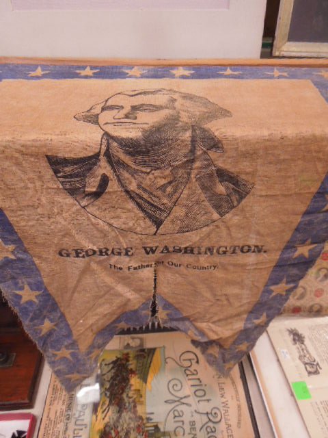 George Washington banner: George Washington banner, flag form, "The Father of Our Country" with center portrait, stars on boarder Condition; wear and edge fraying tear at bottom