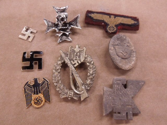 Reproduction German Nazi pins & patch: Reproduction German Nazi pins & patch including; (4) metal - skull, helmet rifle and eagle, plus (3) swastika (1 with eagle + 1 pendant), plus 1 eagle and swastika uniform patch (may be authentic) Con