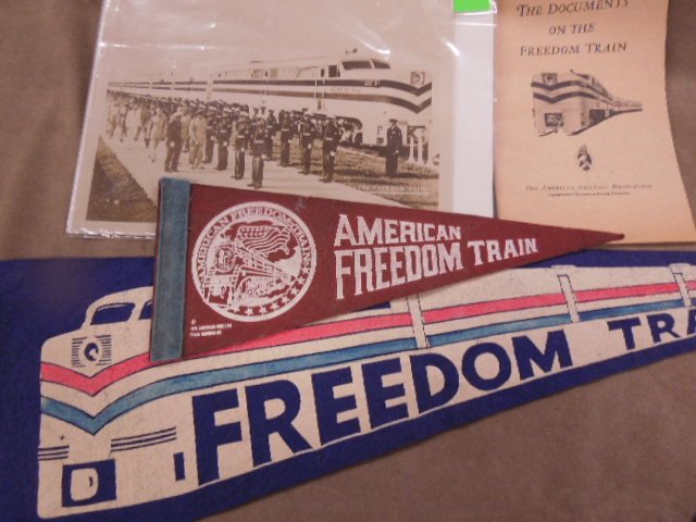 The American Freedom Train items: The American Freedom Train items including (2) pennants, 26" with train and 12", plus booklet, The Documents on the Freedom Train (1947) and 8 x 9 1/2 photo with Military Condition; minor wear on penn