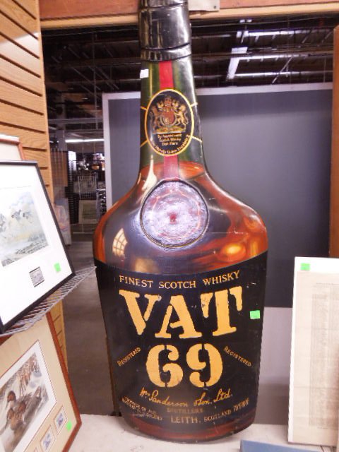 Vintage Tin Vat 69 Whiskey Advertising sign: Vintage Tin Vat 69 Whiskey Advertising sign, Bottle form, tin over wood, Scotch Whiskey Distiller to Her Majesty the Queen, Wm Sanderson & Son Ltd. Leith, Scotland, 60" h Condition; some wear and scra
