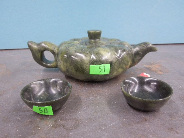 Chinese Jade Teapot & 2 Cups: Chinese jade teapot and 2 cups, spinach green jade in squat melon form, 20th c. teapot 7" x 2 1/4" x 4 1/2". cups 1 7/8" diam. CONDITION: No issues noted.