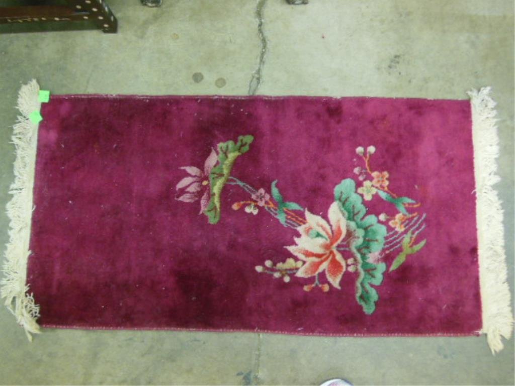 Chinese Nichols throw rug: Chinese Nichols type throw rug, 48" x 23" in maroon with single floral design, early 20th c. CONDITION: Good, slight wear along edges.