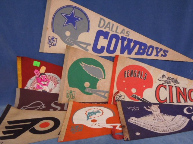 7 Sports Team Pennants: 7 Sports Team Pennants including; Cleveland Indians and Bengals, Philadelphia Flyers and Eagles, Miami Dolphins, Chicago Cubs, and Dallas Cowboys, 28" - 30" Condition; all have some wear and pinholes,