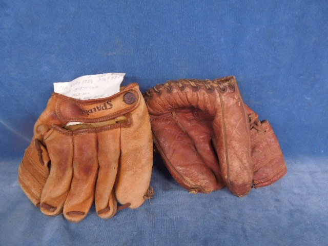2 Vintage baseball gloves: 2 Vintage baseball gloves. Including: Dinkin, Ned Schoesidienst? and Spalding, 1165 Carlton Lilly. Cond: Both gloves gloves have wear from age and use.