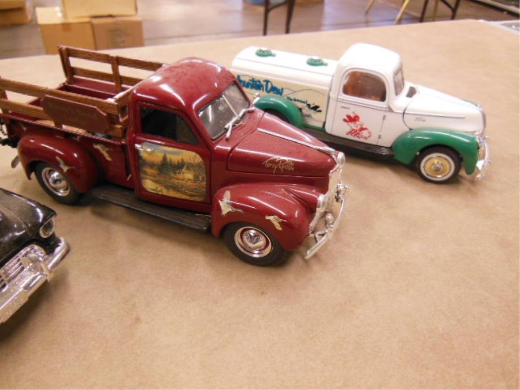 3 Ertl Delivery trucks: 3 Ertl delivery trucks including (1) bank with key Ace hardware), plus Mountain Dew and Terry Redlin stake body Condition; some wear from display