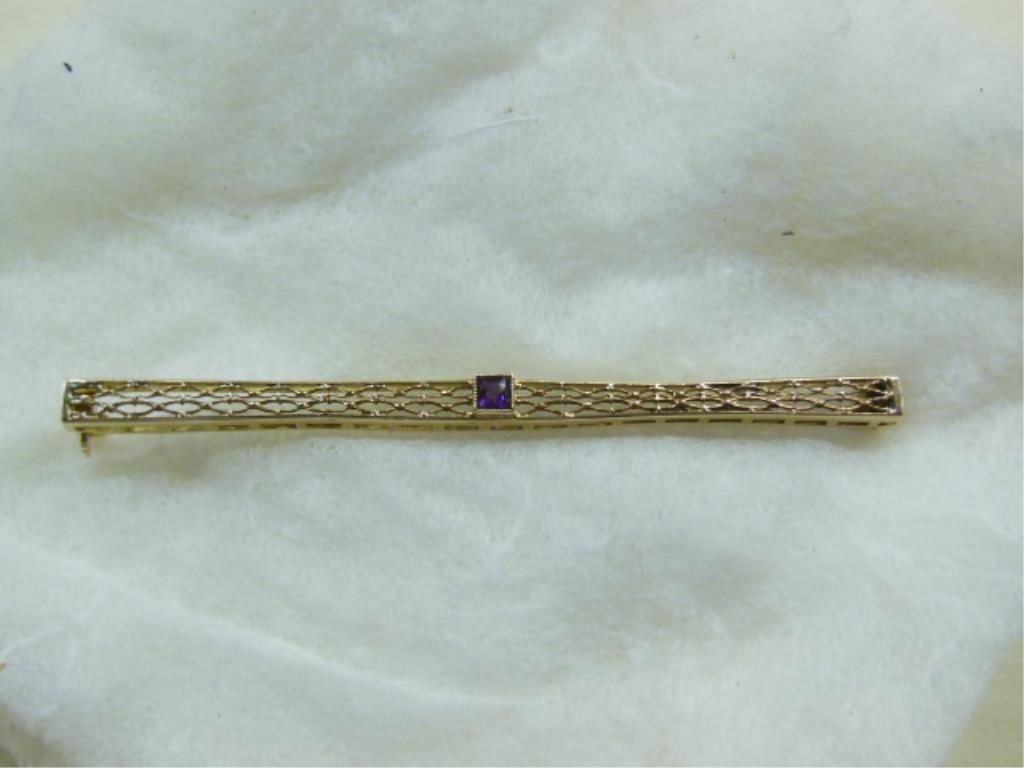 14k Gold Bar Pin: 14k gold bar pin, yellow gold filigree bar with square cut amethyst in conforming bezel, length 2 1/2", 2 DWT. CONDITION: Slight dents on edges.